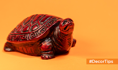 What are the advantages of having a tortoise figurine in your home?